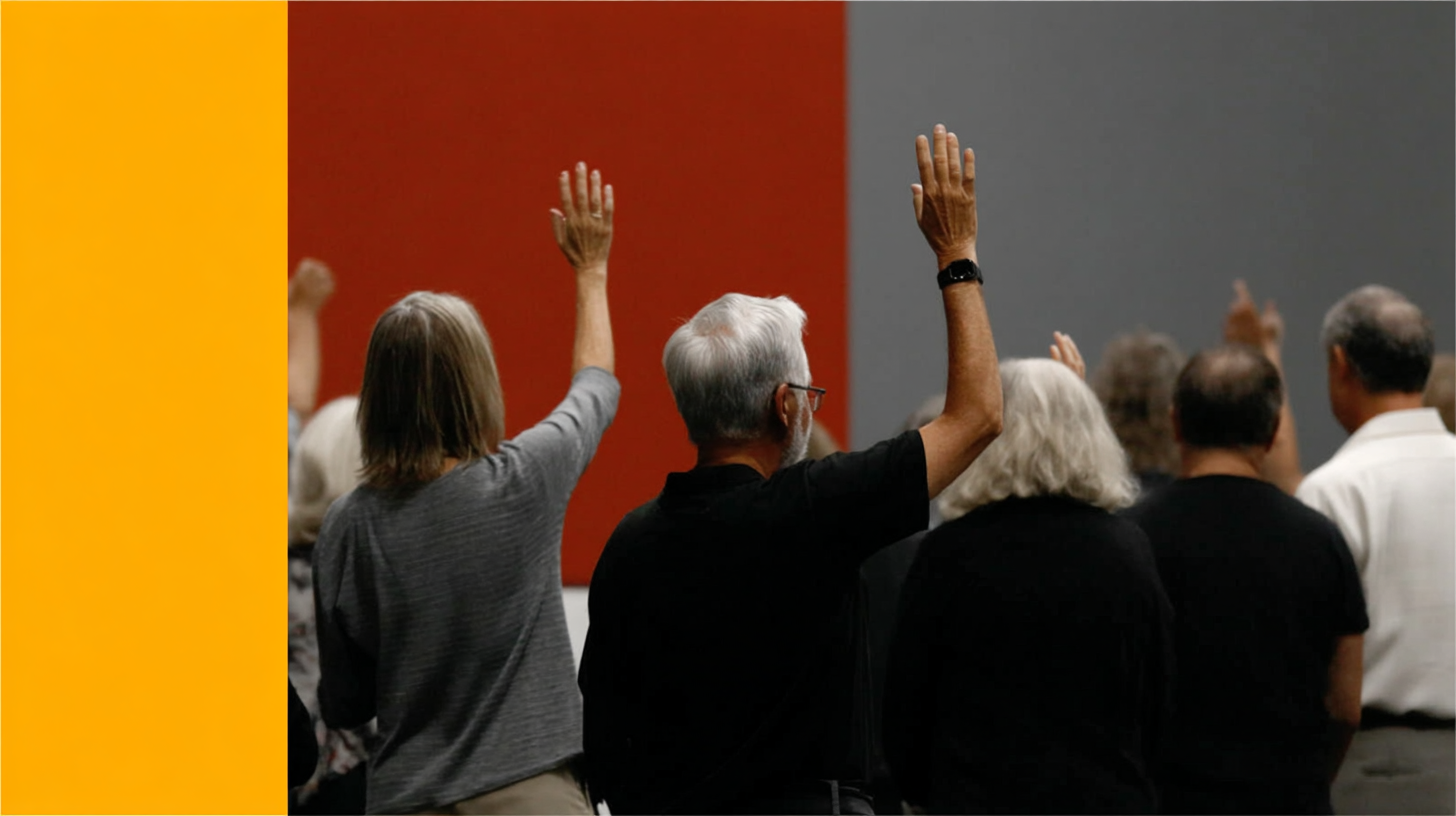 People worshipping with raised hands in a modern church setting, emphasizing community and spiritual engagement.