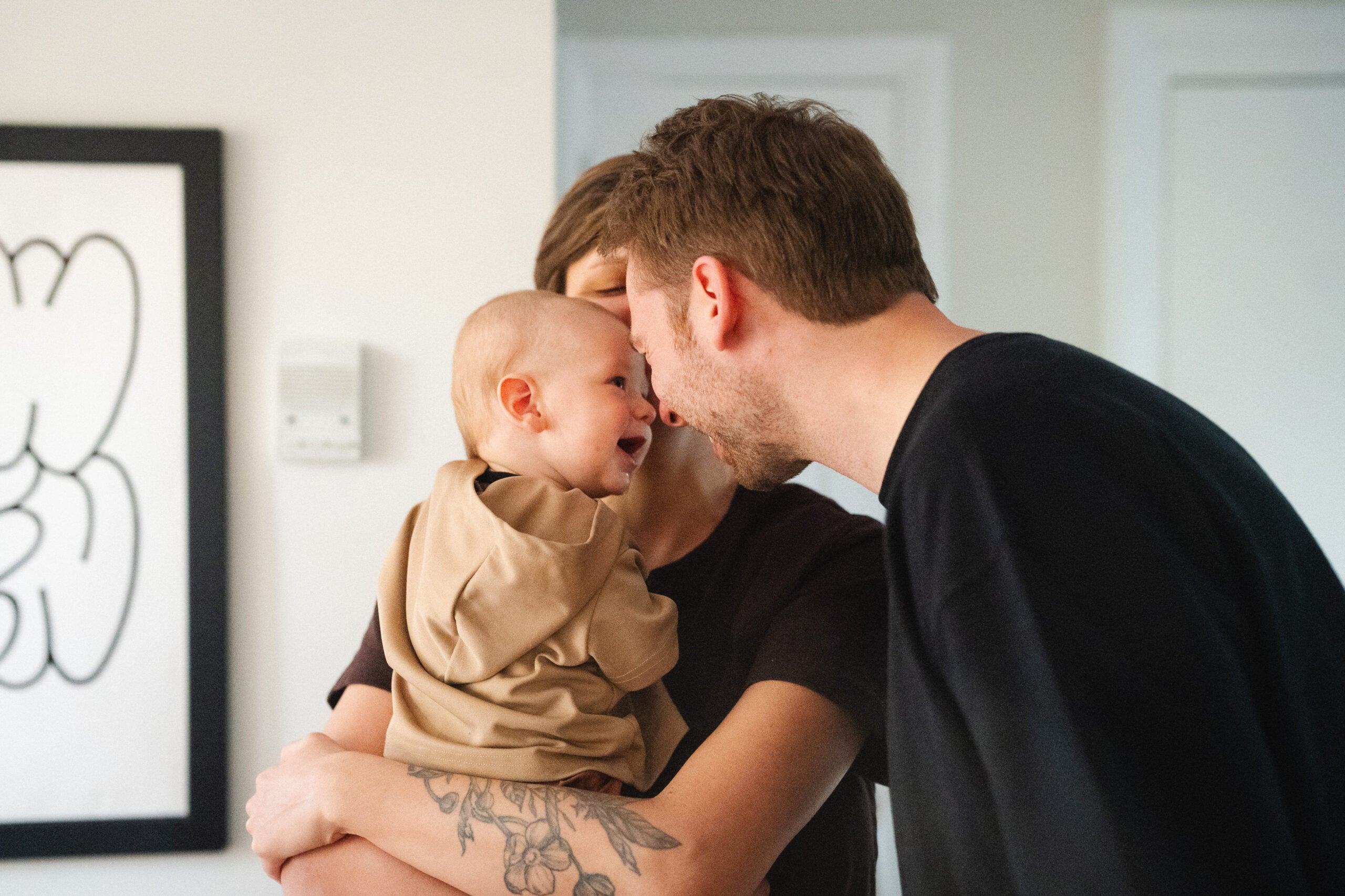 Family sharing a joyful moment, with a parent and child engaging in affectionate play, symbolizing community and support in leadership development within the Multiply organization.