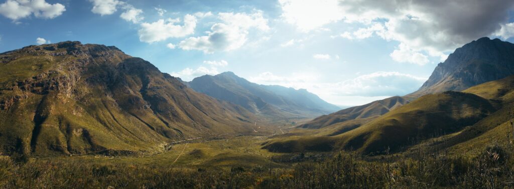 Rocky mountain valley under blue sky