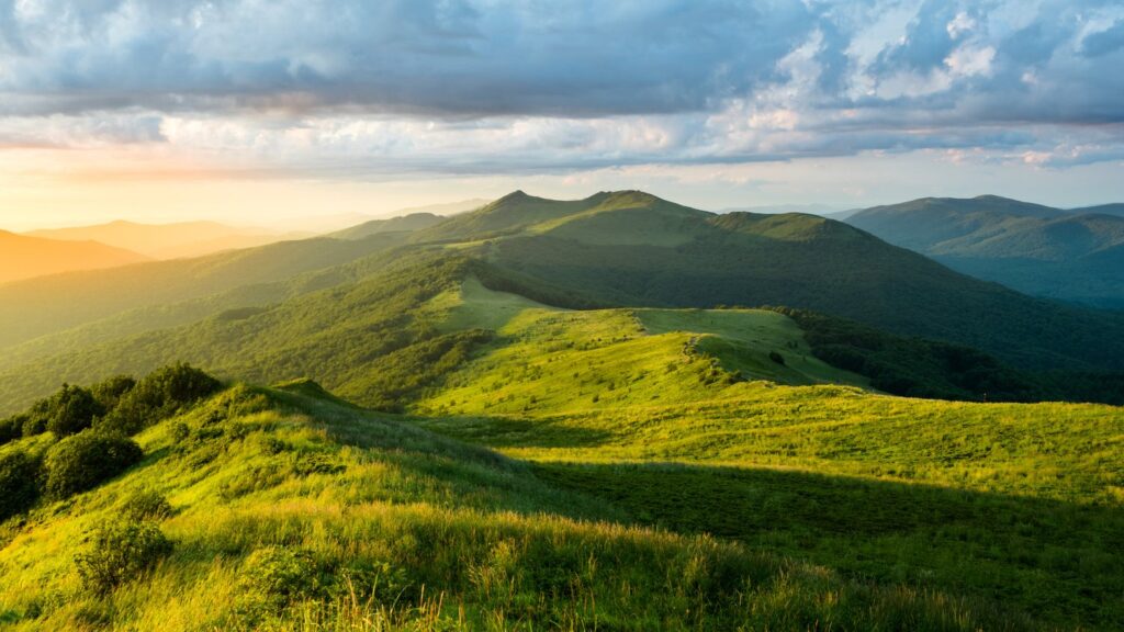 Rolling green hills under cloudy sky