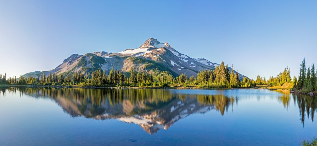 Snow-capped mountains reflected in a calm lake