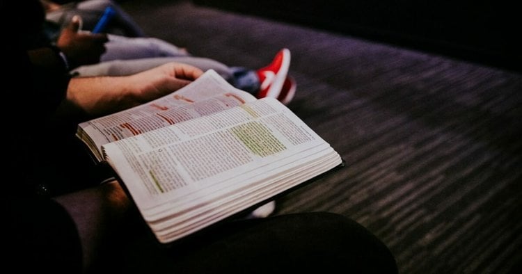 Open Bible with pen resting on pages