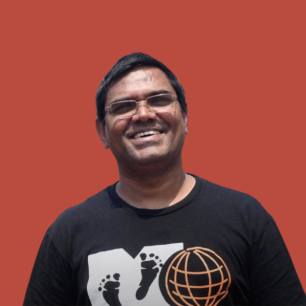 Portrait of man smiling against red background