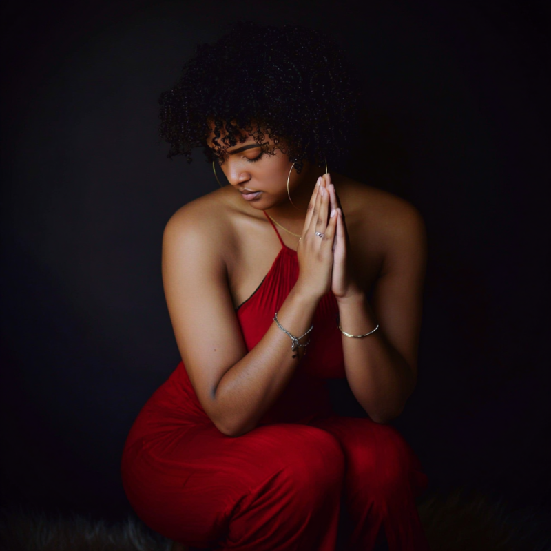 Woman in red dress praying, symbolizing community involvement and spiritual connection, relevant to Multiply the Church's initiatives.