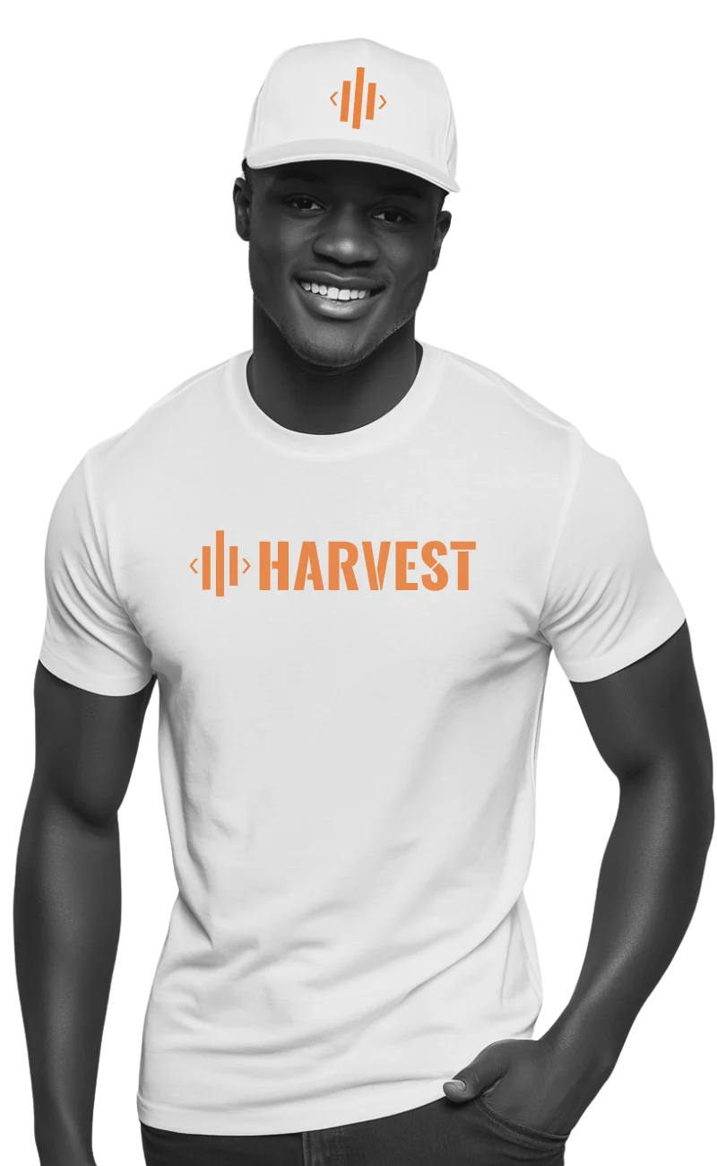 Person wearing “Harvest” t-shirt standing against white background