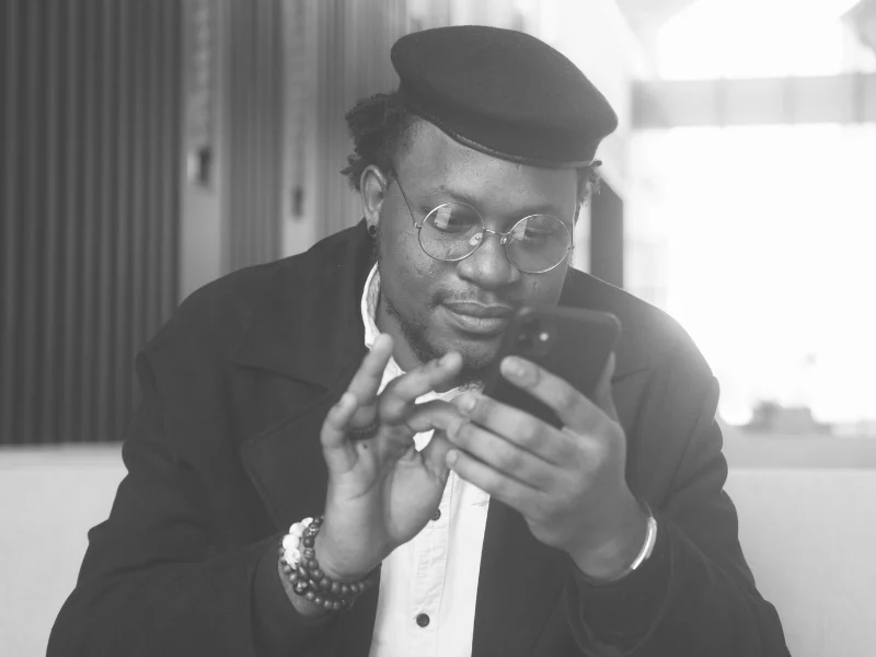 Black and white portrait of person looking at phone